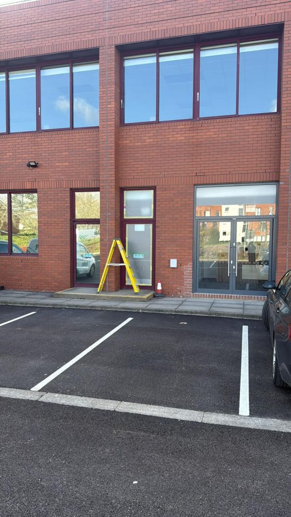 Exterior commercial building spray painting project in Slough completed by ColorLux decorating team