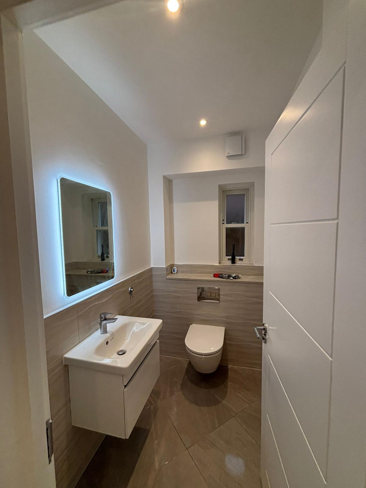 contemporary bathroom design with wall tiles and modern sink Lewisham project